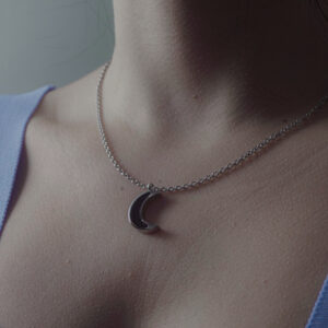Aanyeh Charms' Moon Crescent Necklace filled with sand charms. Embodies the magic of moonlit nights. آنية.