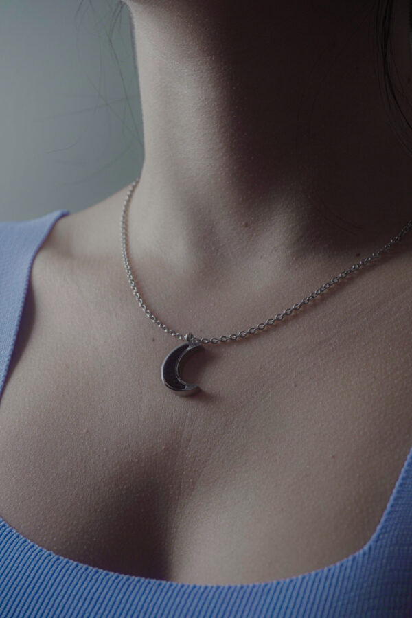 Aanyeh Charms' Moon Crescent Necklace filled with sand charms. Embodies the magic of moonlit nights. آنية.