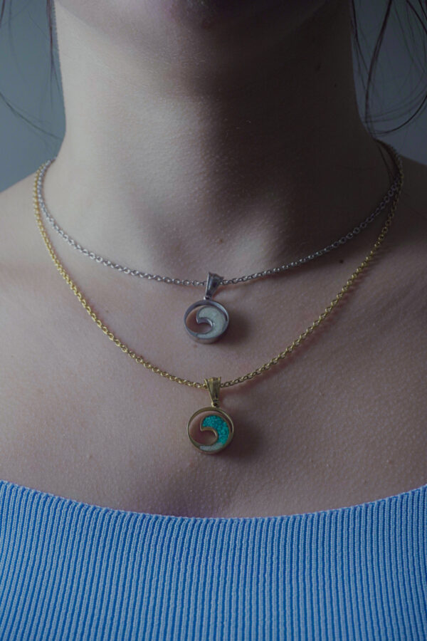 Sea Wave Charm Necklace by Aanyeh Charms, filled with sand. A tribute to the serene and powerful waves of the sea. آنية.