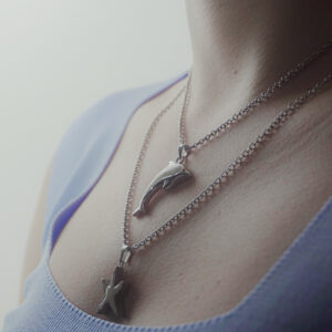 Dolphin Charm Necklace by Aanyeh Charms. Handcrafted with sand charms, capturing the playful spirit of dolphins. آنية.