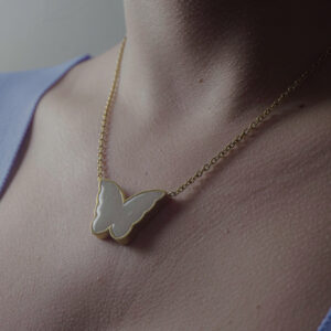Butterfly Charm Necklace by Aanyeh Charms, filled with sand. A symbol of transformation and beauty. آنية.